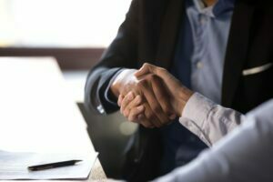 Close up african american businessman shaking hands with caucasian client. Handshake is symbol of starting finishing negotiations, successful teamwork signing contract, hiring human resource concept